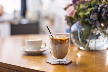 Glass of iced coffee on a cafe table 