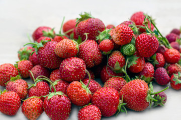 Natural organic food production. Freshly picked juicy strawberries on wooden background. Heap of...