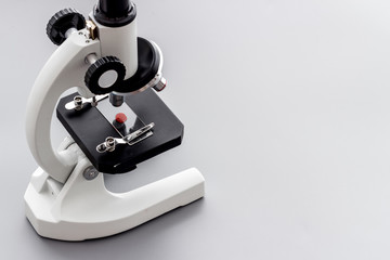Laboratory examination with microscope. Equipment on grey background