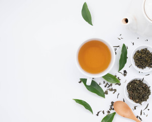 cup with tea and teapot on white background, over light
