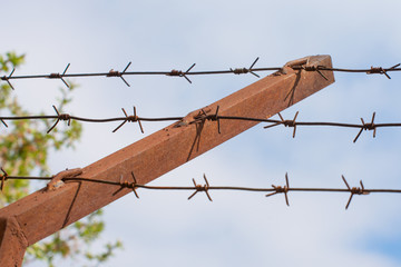 Fencing of a prison with barbed wire.