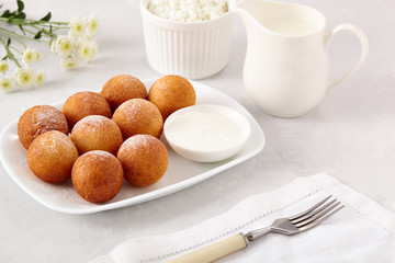 Beautiful breakfast. Cottage cheese donuts  balls  on a light background.