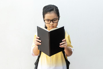 Asian girl elementary school with book and bag. Back to school. education concept