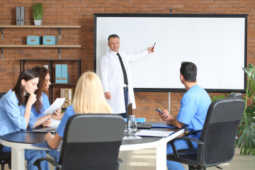 Male lecturer teaching medical students in university