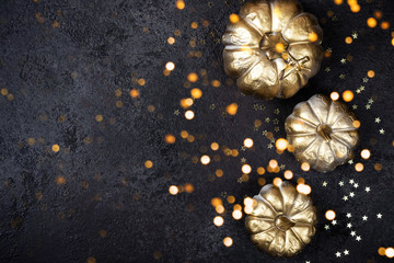 Obraz na płótnie Canvas Shining Golden pumpkins on black. Festive Halloween or Thanksgiving Day background for your design