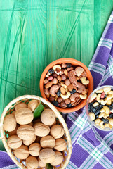 several kinds of nut brown bowl of walnuts on a green background ad space	