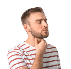 Young man checking thyroid gland on white background