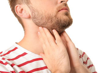 Obraz premium Young man checking thyroid gland on white background, closeup