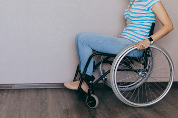 Unrecognizable disabled woman in wheelchair at home. Recovery and healthcare concepts.