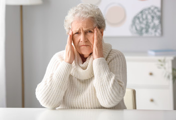 Elderly woman video chatting with doctor at home