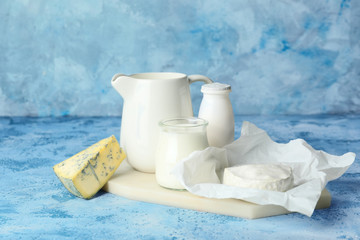 Different dairy products on color background