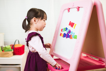 toddler girl learning letter blocks for homeschooling