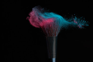 Blue and pink makeup on powder brush hit in a mixed cloud