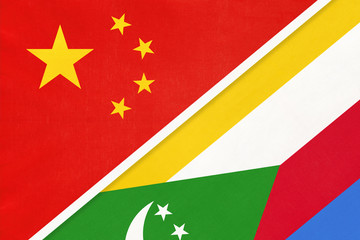 China or PRC vs Union of the Comoros national flag from textile. Relationship between Asian and African countries.