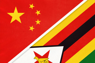 China or PRC vs Zimbabwe national flag from textile. Relationship between Asian and African countries.