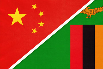 China or PRC vs Zambia national flag from textile. Relationship between Asian and African countries.