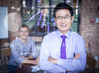 Two entrepreneurs in office and virtual identification graphics. Closeup of smiling senior Asian businessman standing with arms crossed. People looking at camera. Front view.