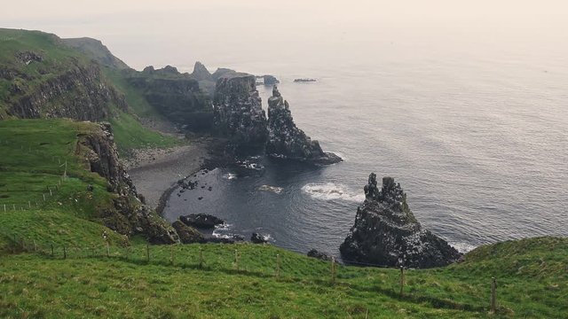 Green Mountain Cliffs With Seabirds Flying At The Bird Sanctuary In Rathlin Island, Northern Ireland - wide shot