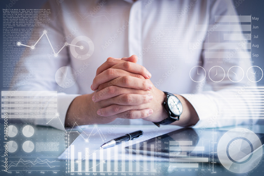 Poster male executive sitting at table with virtual statistic graphics. man with clasped hands. caucasian h