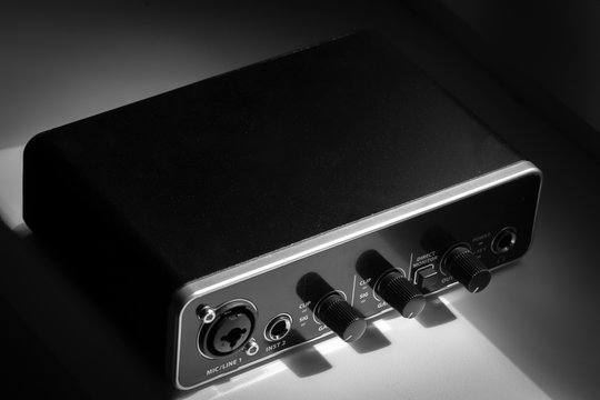 Black metal audio interface outdoor at home closeup.