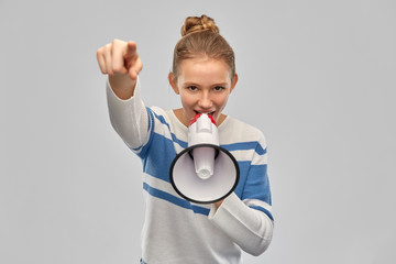 communication, feminism and rights concept - teenage girl speaking to megaphone over grey background