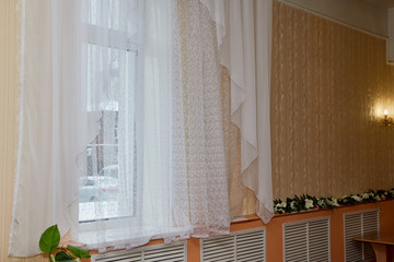 Room window with a white transparent tulle curtain