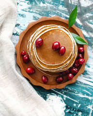 Breakfast. Sweet tasty pancakes with berry  in wooden plate. American pancakes with berries.