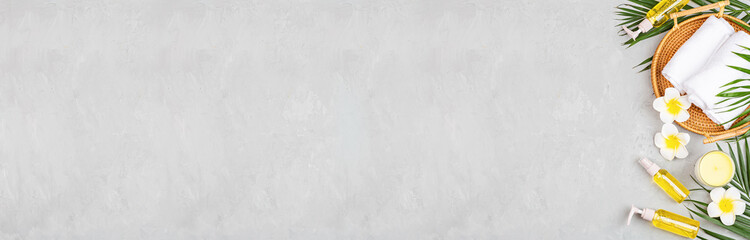 Spa massage Aromatherapy body care background. Spa herbal balls, cosmetics, towel and tropical...