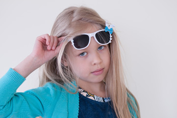 Portrait of a blonde girl in dark glasses