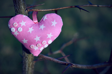 An image of a soft toy in the shape of a heart. Handicraft work.