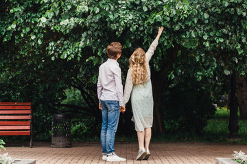 Naklejka premium Girl and man hug each other on a walk, love, relationships, attitudes, conversations, first kiss, youth, creating a family