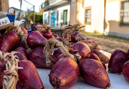 Red onions from Tropea (cipolla rossa di Tropea) at a farmers market in Italy