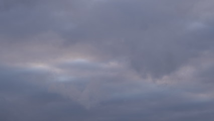 A beautiful evening blue sky at sunset with flaming bright light clouds. Warm evening.