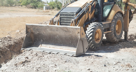 Excavator works at a construction site.