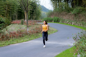 A young Asian female running outdoors