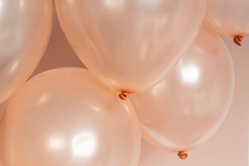 rose gold color hellium balloons flying