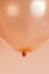 rose gold color hellium balloons flying