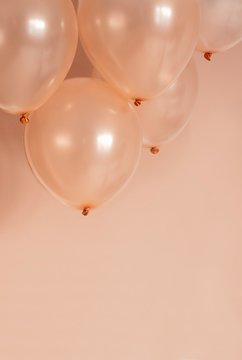 rose gold color hellium balloons flying