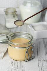 freshly prepared home-made condensed milk, on a light background
