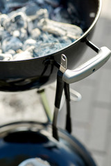 cooking, bbq and grilling concept - close up of charcoal smoldering in brazier outdoors