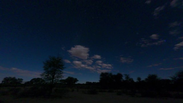 A wide angle timelapse at night, clearly showing the stars rotating and clouds moving quickly overhead. Filmed in the Kalahari desert of Southern Africa.