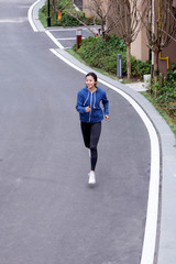 A young Asian female running outdoors