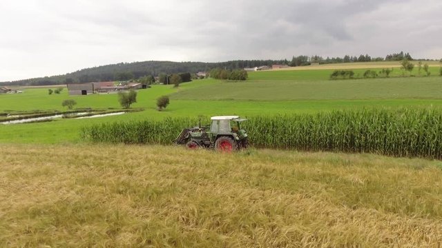 Tractor drives across a field.