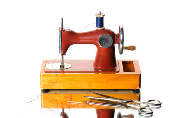 Retro sewing machine with scissors and bobbin. Children's Soviet sewing machine toy.