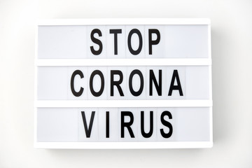 medicine, epidemic and healthcare concept - lightbox with stop coronavirus caution words on white background