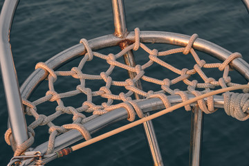 Detail of the rigging equipment on the yacht. Sailing at sunset. Yachting concept and sea background