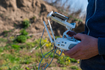 Drone remote control in hand man.Man operating of flying drone