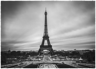 Dramatic Eiffel tower in France without people and cars around and empty streets of  Paris. Postcard apocalyptic  concept image of Black and white.