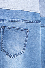 back pocket of denim trousers. with ripped denim jeans close up for pregnant women