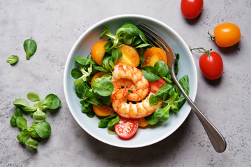 Prawns salad with cherry tomatoes, corn salad and spices. Healthy food, clean eating, dieting, top view